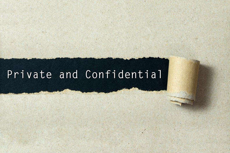 Private and confidential written on torn paper black background
