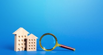 Residential buildings and magnifying glass. Search for real estate to buy. Long-term and short-term rental of apartments and housing. Realtor services. Important things when choosing a property.