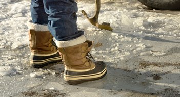 Man Chopping Ice in the Driveway