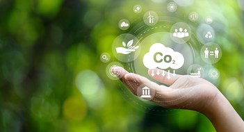 Sustainability in Multifamily Buildings CO2 emission reduction concept in hand with environmental icons, global warming, sustainable development, connectivity and renewable energy green business background.