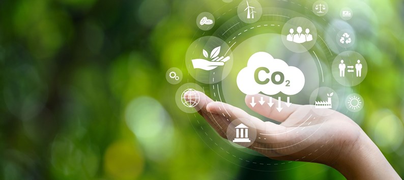 CO2 emission reduction concept in hand with environmental icons, global warming, sustainable development, connectivity and renewable energy green business background.