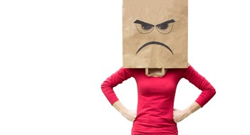 Woman with paper bag on her head with an angry expression on it