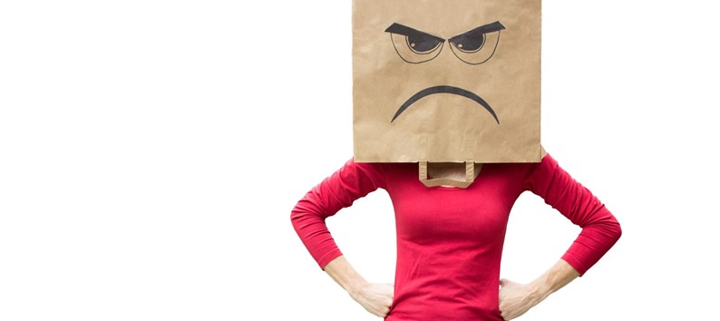 Woman with paper bag on her head with an angry expression on it
