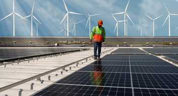 New Energy Technology Inspector Engineer Man Holding Digital Tablet Working in Solar Panels Power Farm, Photovoltaic Cell Park, Green Energy Concept.