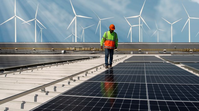 Inspector Engineer Man Holding Digital Tablet Working in Solar Panels Power Farm, Photovoltaic Cell Park, Green Energy Concept.