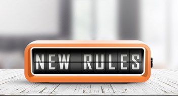 Amending Bylaws  and House Rules New rules alarm message on a wooden desk in a bright indoor environment