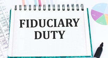 Fiduciary Duty Explained Text Fiduciary Duty on notepad in front of an office desk