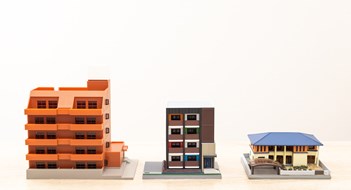 Small Condo Associations Model of a house placed on a desk