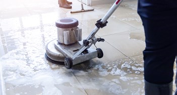 Boosting Curb Appeal on a Budget Janitor use floor scrubber machine on the floor hallway office building or walkway after school and classroom work job with sun light background. Wet floor or cleaning service house maid concept.