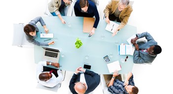 Making the Most of Your Annual Board Meeting Overhead view of a group of business people at meeting.