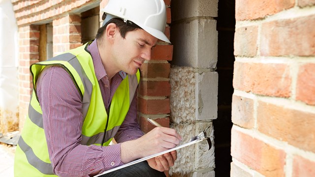 Architect Checking Insulation During House Construction