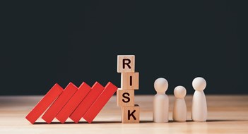 Don’t Lose Your Insurance Coverage Financial Crisis, Economic, Business Risk Management Concept. Risk word on wooden block, domino effect falling to family. Concept Risk, Crisis, Management, Assessment, Insurance, Security, Finance