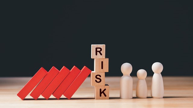 Financial Crisis, Economic, Business Risk Management Concept. Risk word on wooden block, domino effect falling to family. Concept Risk, Crisis, Management, Assessment, Insurance, Security, Finance