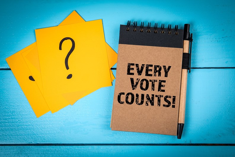 Every Vote Counts. Notebook, Pen, and Question Mark Cards on Blue Table.