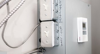 Managing Boiler Maintenance On off power switch for emergency repair or trouble shooting problem with hot water heating system. Selective focus.