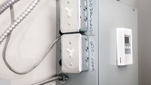 On off power switch for emergency repair or trouble shooting problem with hot water heating system. Selective focus.