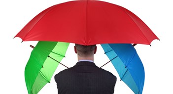 Adequate Community Insurance Coverage Confident businessman with three umbrellas concept for more than adequate ample insurance cover or failsafe backup plan