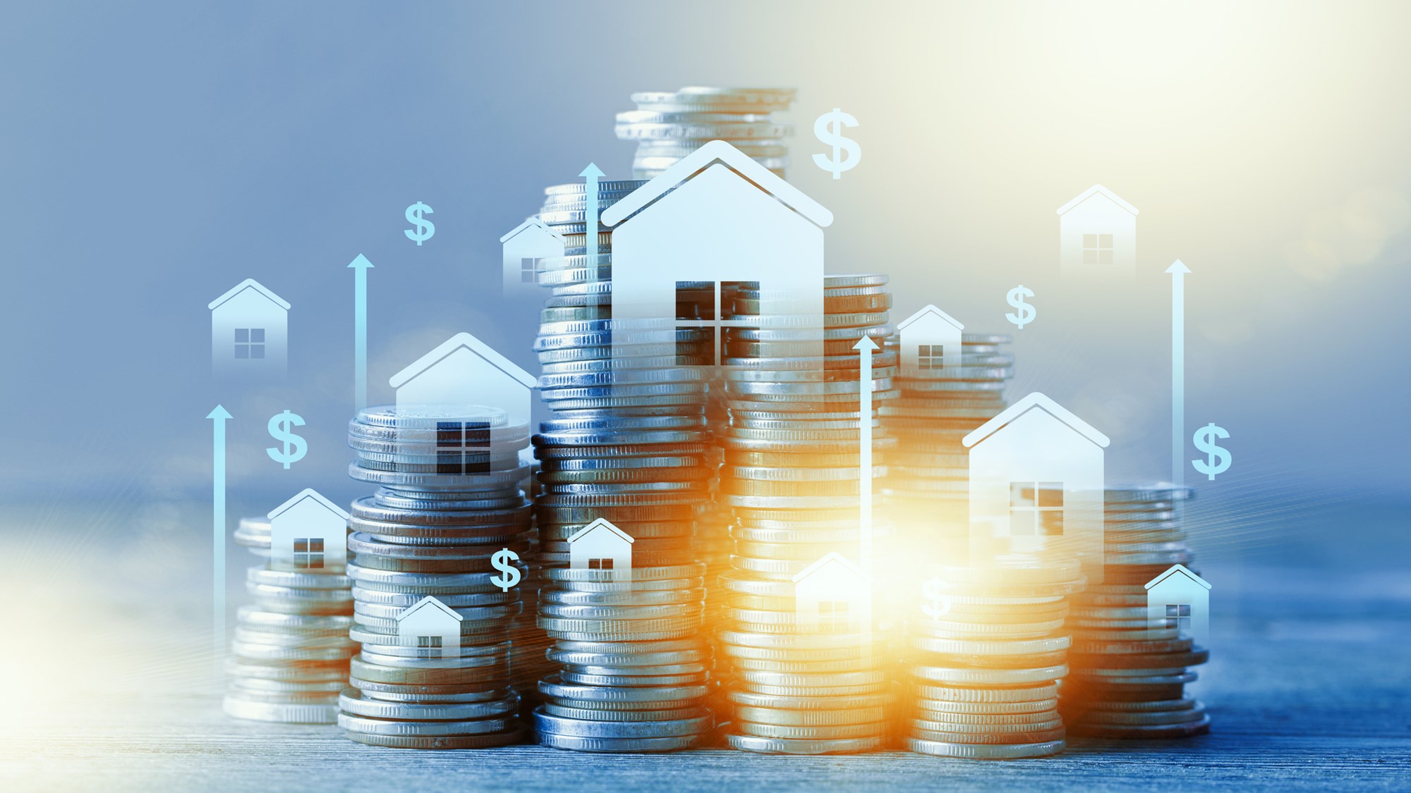 Coins are stacked with house icons on top, showing growth in real estate value with dollar signs.